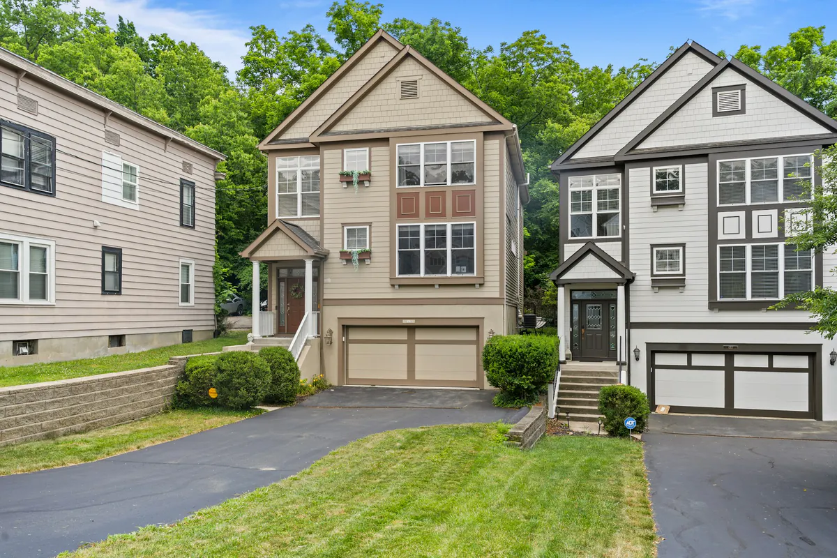 Row of Ohio family homes with driveways and mature trees